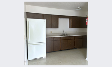 Gonzales apartment for rent - a kitchen with a white refrigerator and a sink