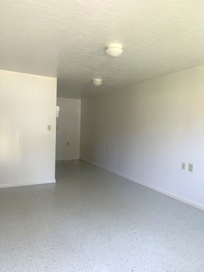 Gloster apartment for rent - an empty living room with white walls and a ceiling light