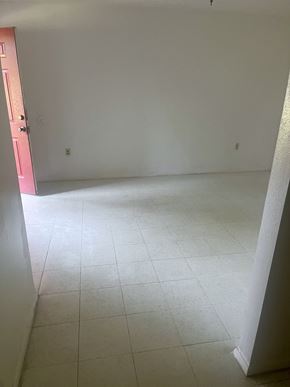 Waynesboro apartment for rent - an empty room with a white tiled floor and a pink door