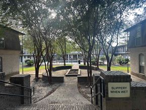 Baton Rouge apartment for rent - A sign warns that the path is slippery when wet.