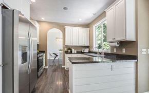 Kentwood house for rent - a kitchen with white cabinets and a stainless steel refrigerator