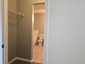 Edmonton apartment for rent - a bathroom with a toilet and a walk in closet