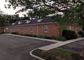 Columbus apartment for rent - an empty parking lot in front of a brick building