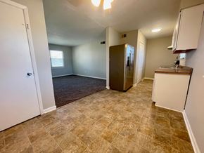 Louisville apartment for rent - A kitchen area with a refrigerator, cabinets, and a countertop.