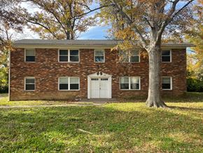 Louisville apartment for rent - A red brick house with a white door and windows.