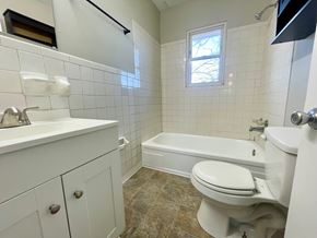 Louisville apartment for rent - A white bathroom with a toilet, sink, and bathtub.