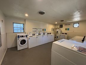 Hattiesburg apartment for rent - A laundromat with a row of washers and dryers.