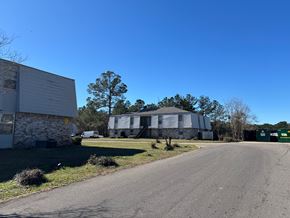 Hattiesburg apartment for rent - A clear blue sky meets a residential area with houses and trees.