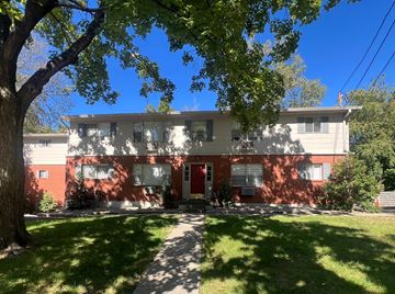 Louisville apartment for rent - a red and white house with a tree in front of it