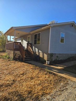 Grayson house for rent - a white house with a front porch and a sidewalk
