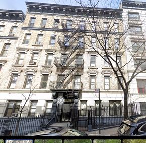 New York apartment for rent - the apartment building has a fire escape on the side of it