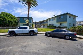 Winnetka apartment for rent - A white truck and a black car are parked in a lot.