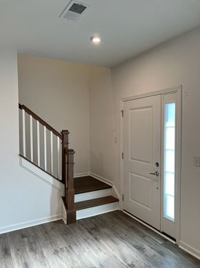 Charlotte house for rent - A white door is on the right side of a staircase.