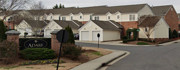 Charlotte house for rent - a street of houses in a suburban neighbourhood with a adare sign