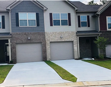 Indian Land house for rent - a white driveway in front of a house with two garage doors