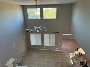 San Tan Valley house for rent - a dining room with a large window and a ceiling fan