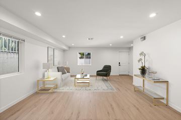 North Hollywood apartment for rent - A living room with a black chair and a white sofa.