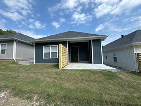 Little Rock house for rent - a blue house with a porch and a door open