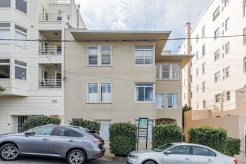 San Francisco apartment for rent - an apartment building with two cars parked in front of it