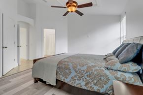 Fort Myers house for rent - A bedroom with a bed and a ceiling fan.