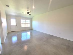 Copperas Cove house for rent - an empty living room with white walls and a ceiling fan