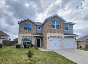 Killeen house for rent - a brick house with a white garage door and a lawn