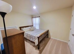 Killeen house for rent - a bedroom with a bed and a dresser and a window