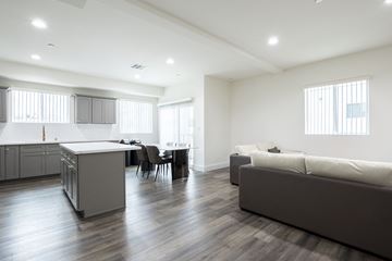 Los Angeles apartment for rent - an open living room and kitchen with a couch and a table