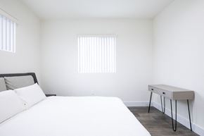 Los Angeles apartment for rent - a white bedroom with a bed and a desk