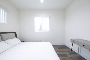 Los Angeles apartment for rent - a bedroom with a bed and a desk and a window
