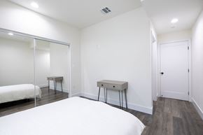 Los Angeles apartment for rent - a white bedroom with a white bed and a mirrored closet