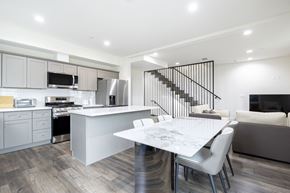 Los Angeles apartment for rent - a white kitchen and dining room with a white table and chairs