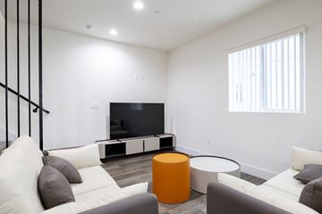 Los Angeles apartment for rent - a living room with a white couch and a television