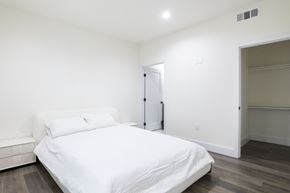 Los Angeles apartment for rent - a white bedroom with a large bed and a closet