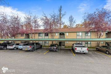 Anchorage apartment for rent - a large building with cars parked in front of it