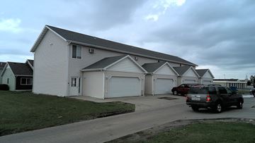 Moorhead house for rent - a large white building with two garages and a parking lot