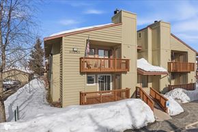 Anchorage apartment for rent - A building with a balcony and a flag on it.