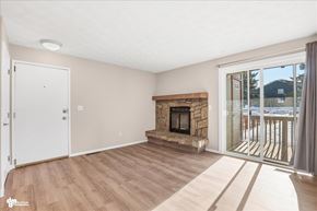 Anchorage apartment for rent - A room with a fireplace and sliding glass doors.