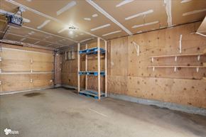 Anchorage apartment for rent - A sparsely furnished room with wooden walls and ceiling, and a concrete floor.