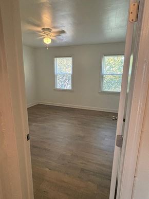 Washington apartment for rent - an empty room with a ceiling fan and two windows