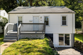 Ferguson house for rent - a small white house with a porch and a deck