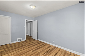 Ferguson house for rent - the living room of a renovated house with wood floors and a door to the hallway