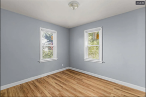 Ferguson house for rent - a bedroom with two windows and a hardwood floor