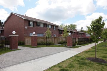 Thornhill apartment for rent - an apartment building with a sidewalk and a fence