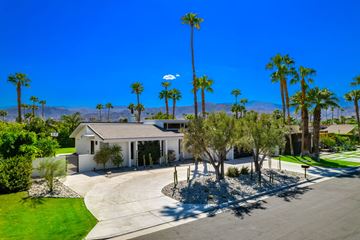 Rancho Mirage house for rent - a house with a driveway and palm trees in front of it