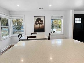 Atlanta apartment for rent - a dining room with a table and chairs in a room with windows