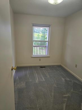 West Liberty house for rent - A room with a carpeted floor and a window.
