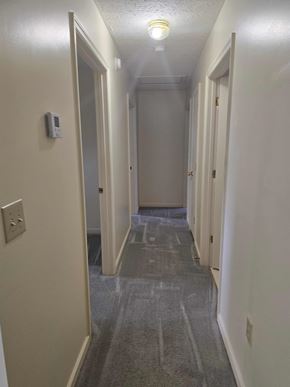 West Liberty house for rent - A long, narrow hallway with a light on.