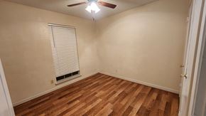 Killeen house for rent - an empty living room with wood floors and a ceiling fan