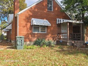 St. Louis house for rent - the front of a brick house with a green mailbox